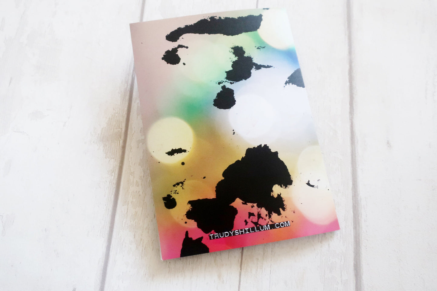 Colorful card with black abstract design on a white surface