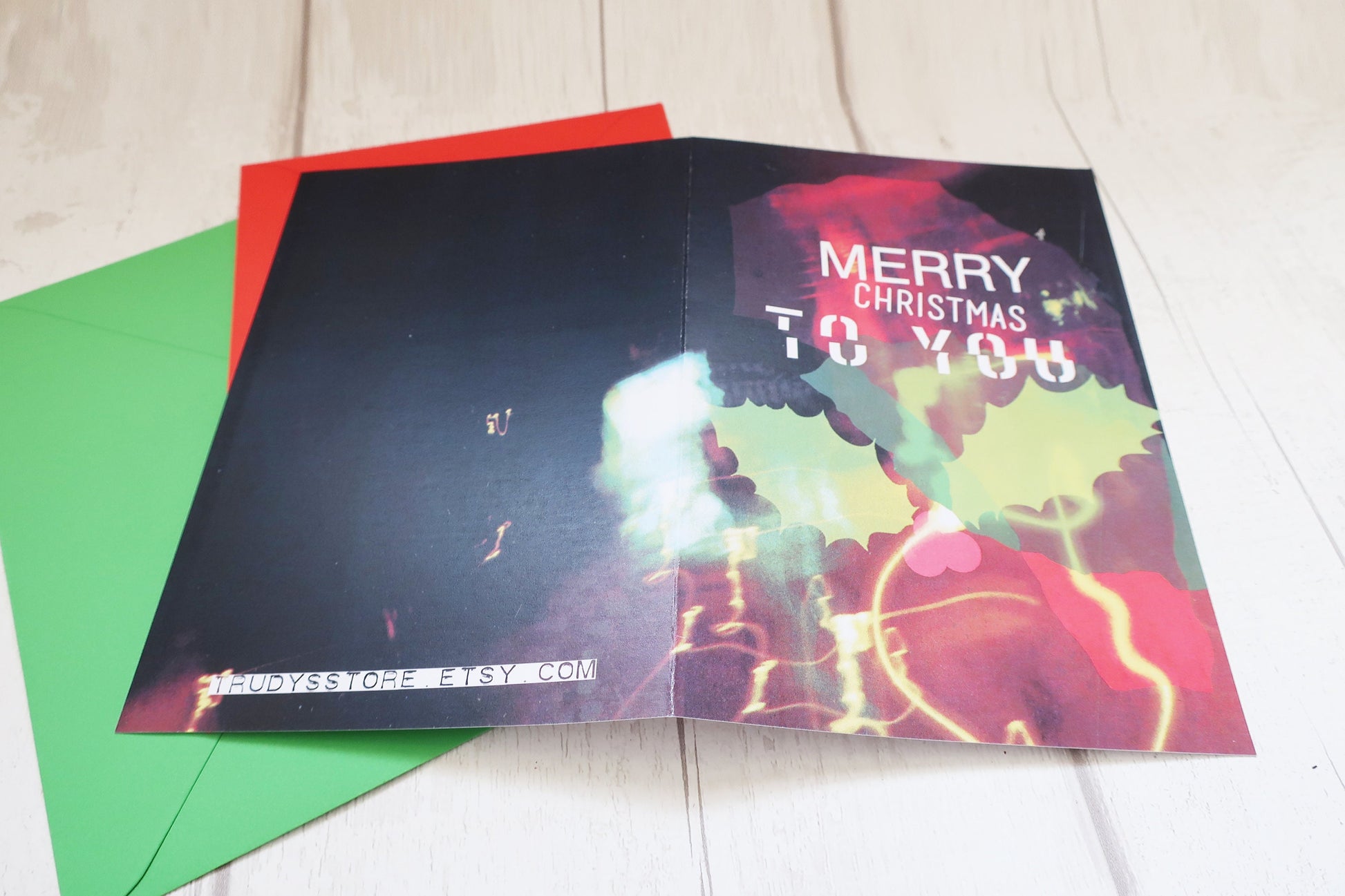Colorful Christmas card with 'Merry Christmas to you' text on a white surface.