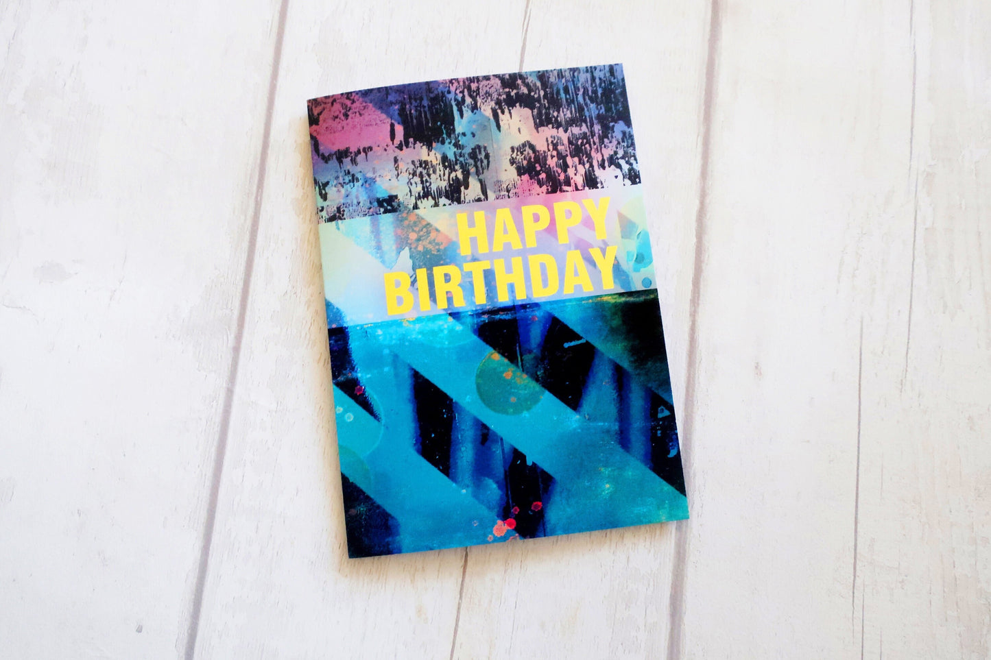 Colorful birthday card with abstract design on a white surface