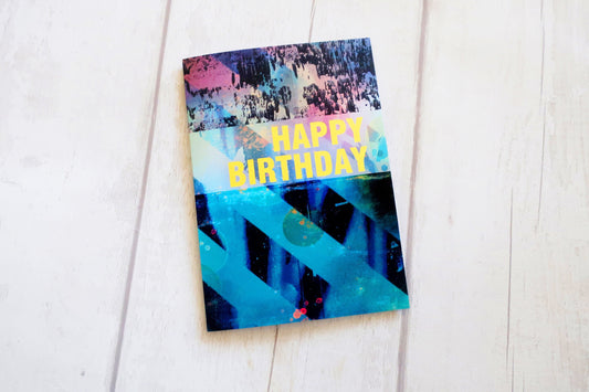 Colorful birthday card with abstract design on a white surface