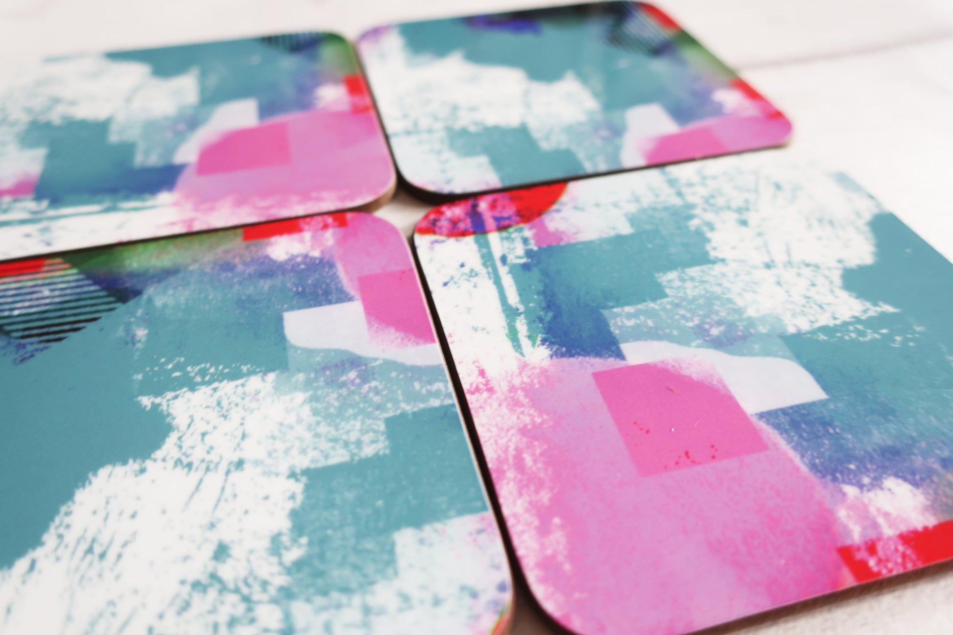 Set of colorful coasters with abstract patterns on a white surface