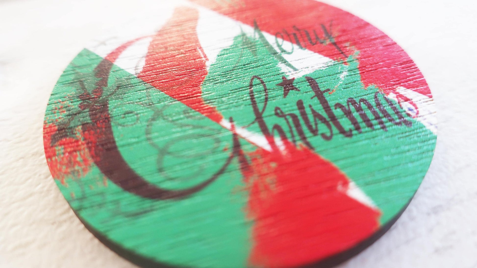 Round Christmas-themed badge  with 'Merry Christmas' text on a white background