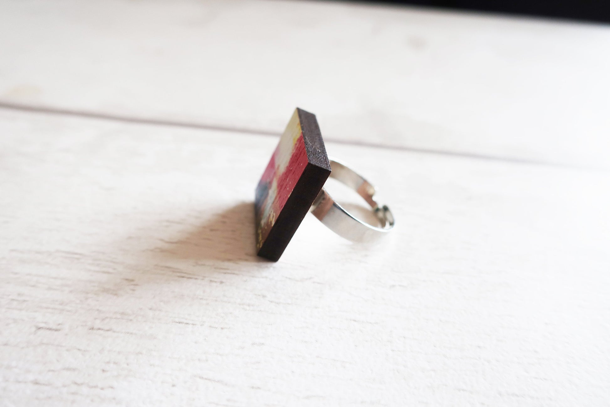 Ring with multicolored pattern on a white surface