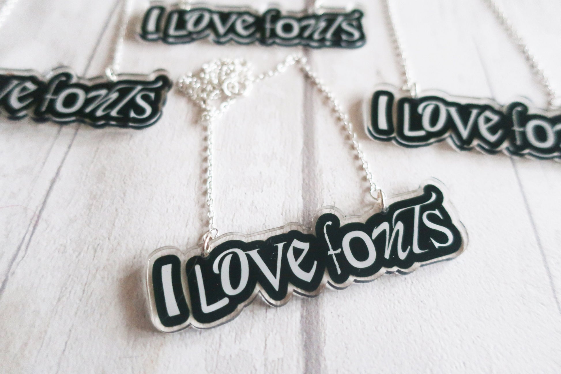 Necklace with 'I Love Fonts' pendant on a white background