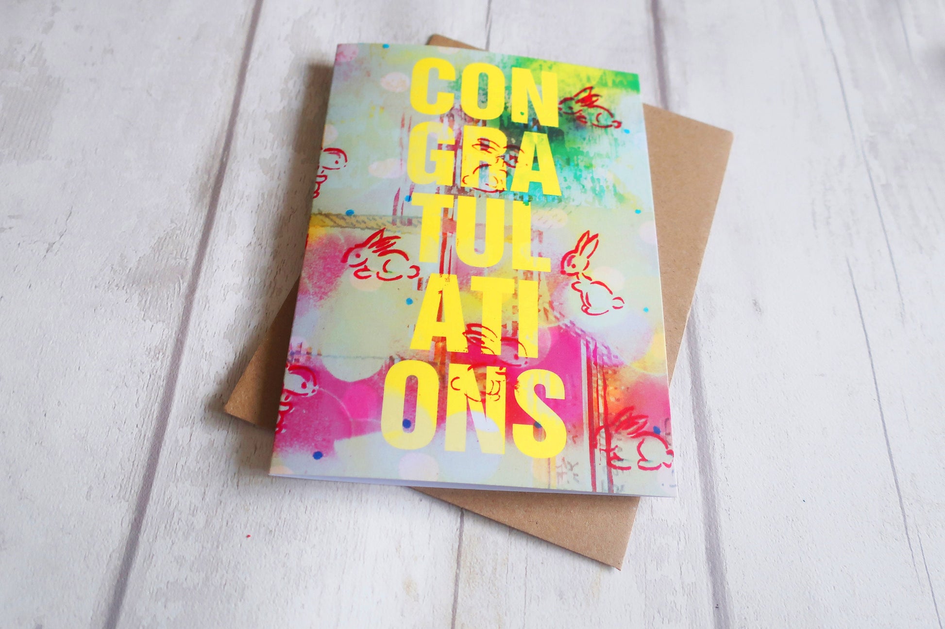 Colorful congratulatory card on a wooden surface