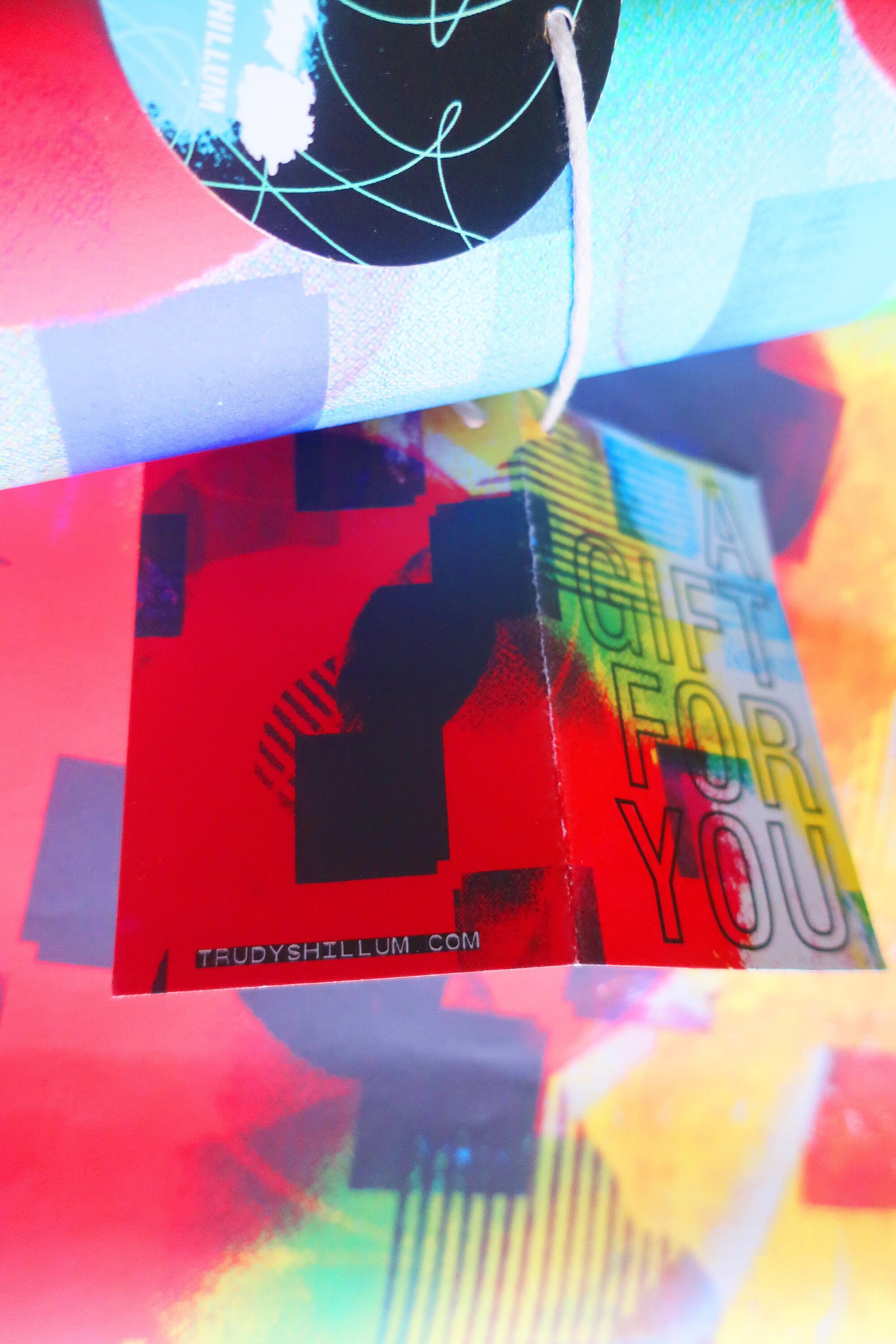 Colorful gift card with text and a website URL on a multicolored background