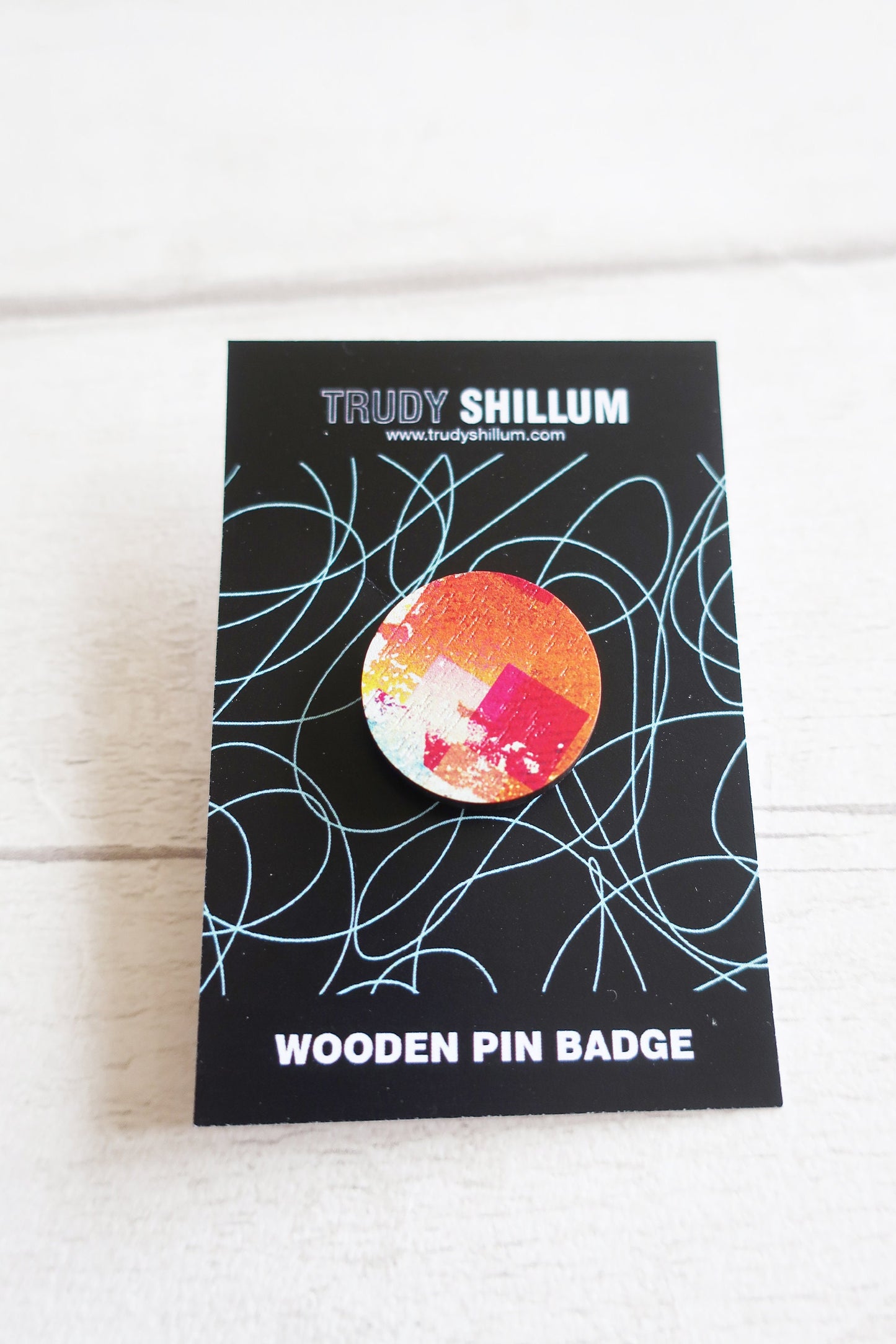 Trudy Shillum wooden pin badge packaging on a white background