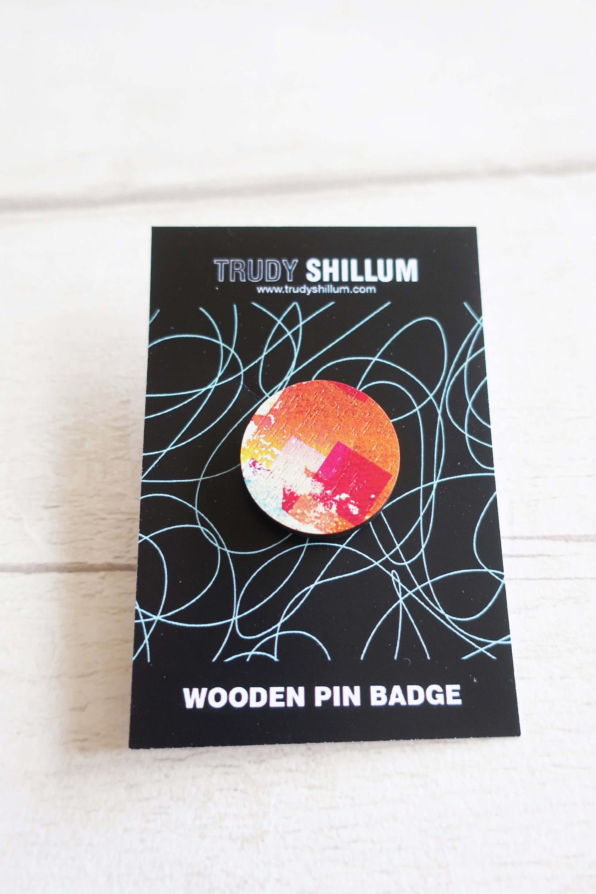 Trudy Shillum wooden pin badge packaging on a white background