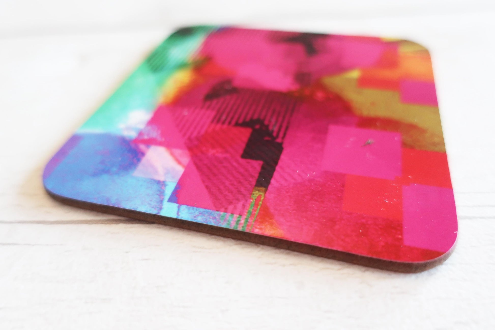 Colorful coaster with abstract design on a white surface
