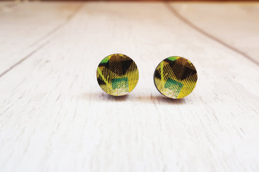 Round earrings with green and black pattern on a white surface