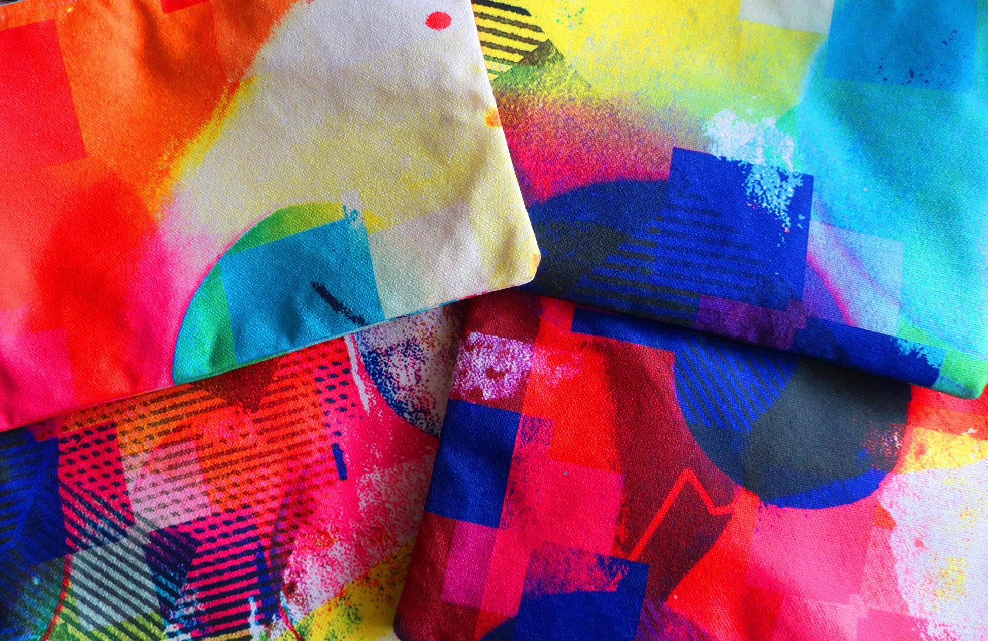 Colorful abstract fabric patterns in red, blue, yellow, and green.