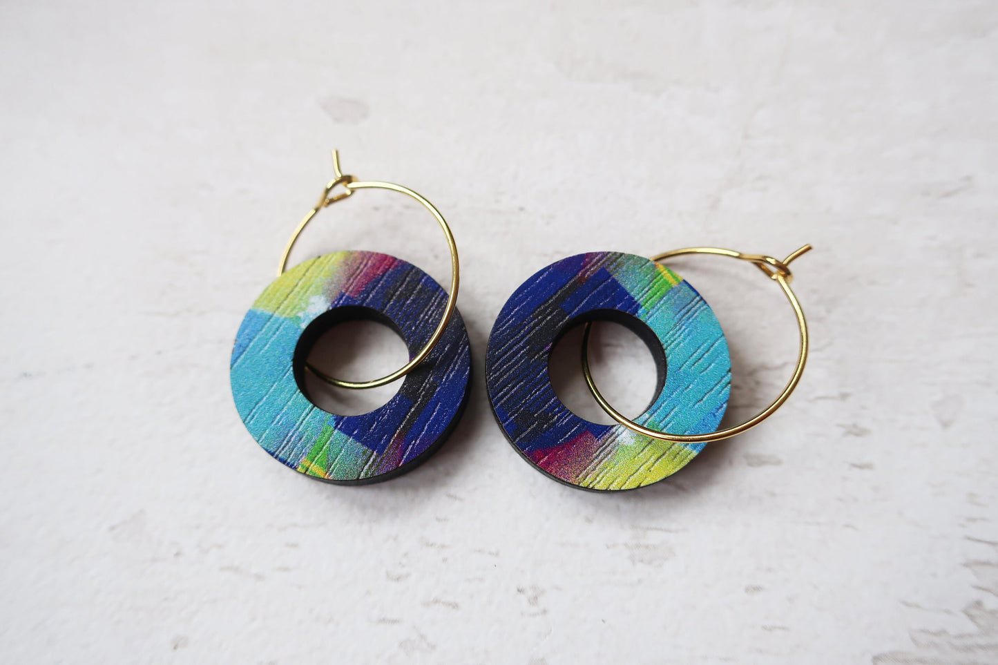 Colorful hoop earrings on a light gray background
