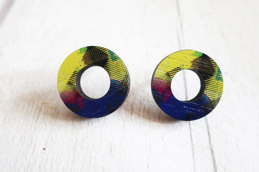 Pair of round earrings with colorful patterns on a white background