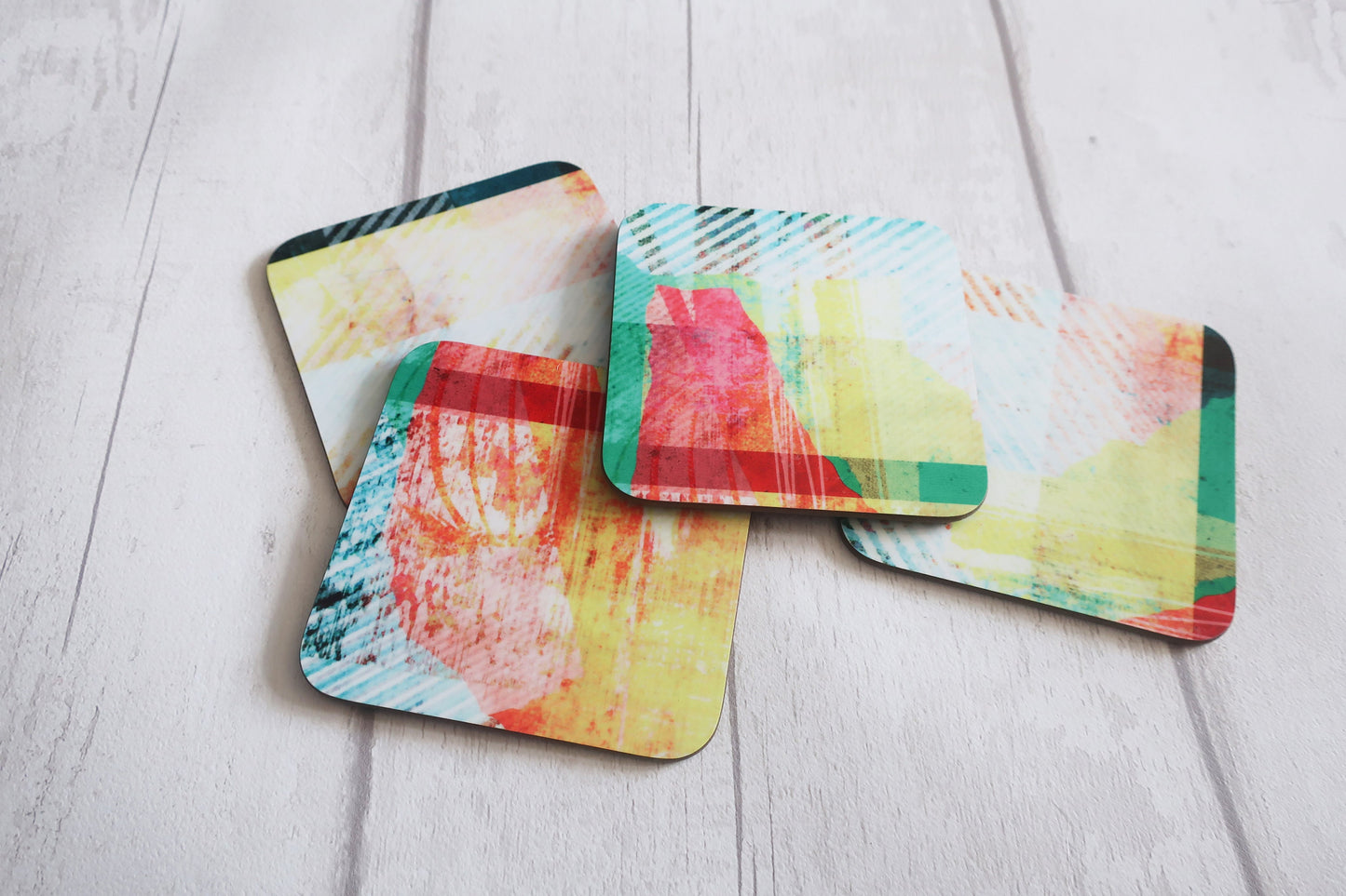 Set of colorful coasters on a light wooden surface