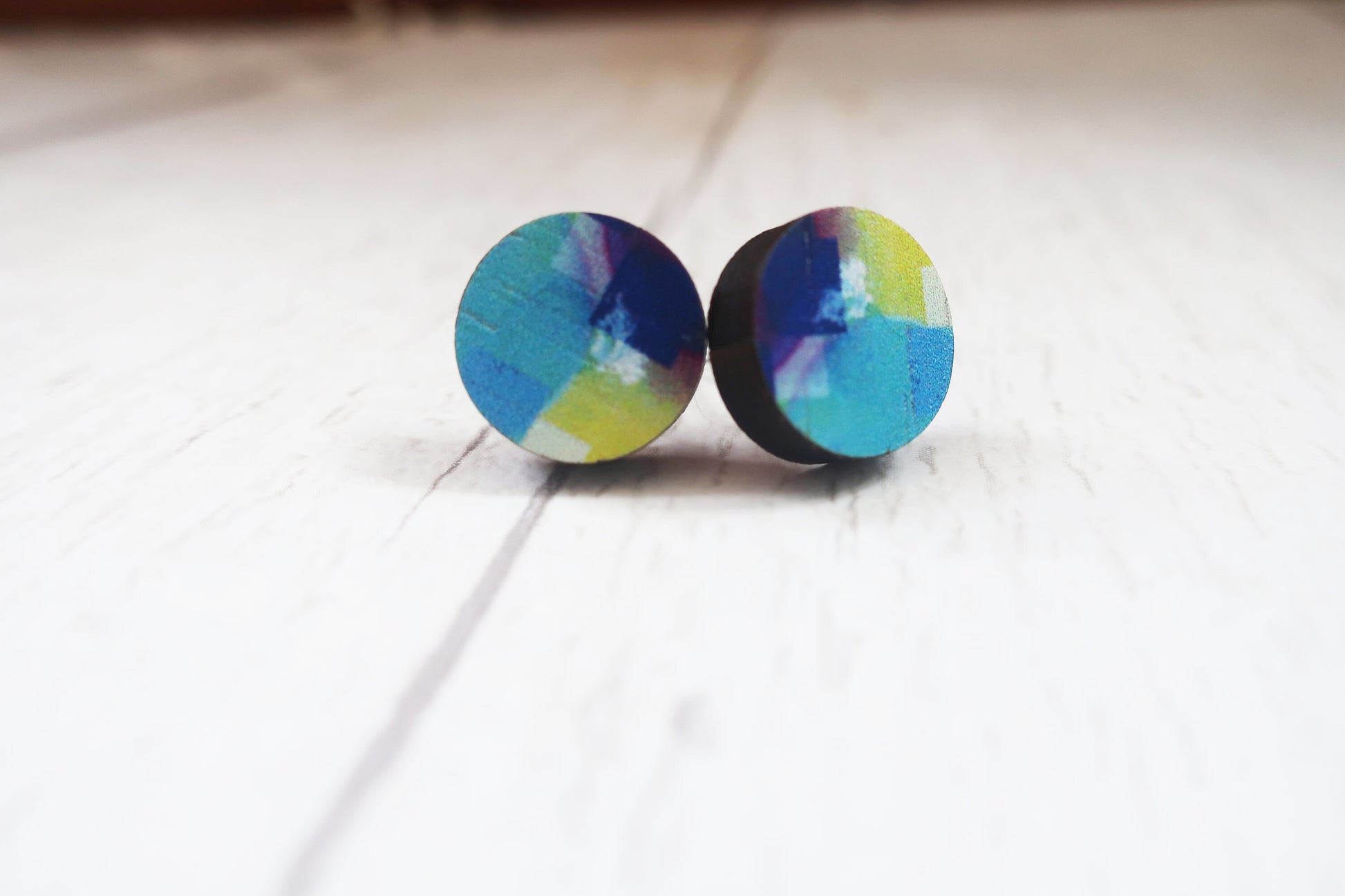 Colorful round earrings on a white background
