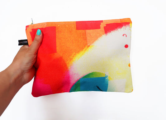 Colorful pouch held by a hand with a white background