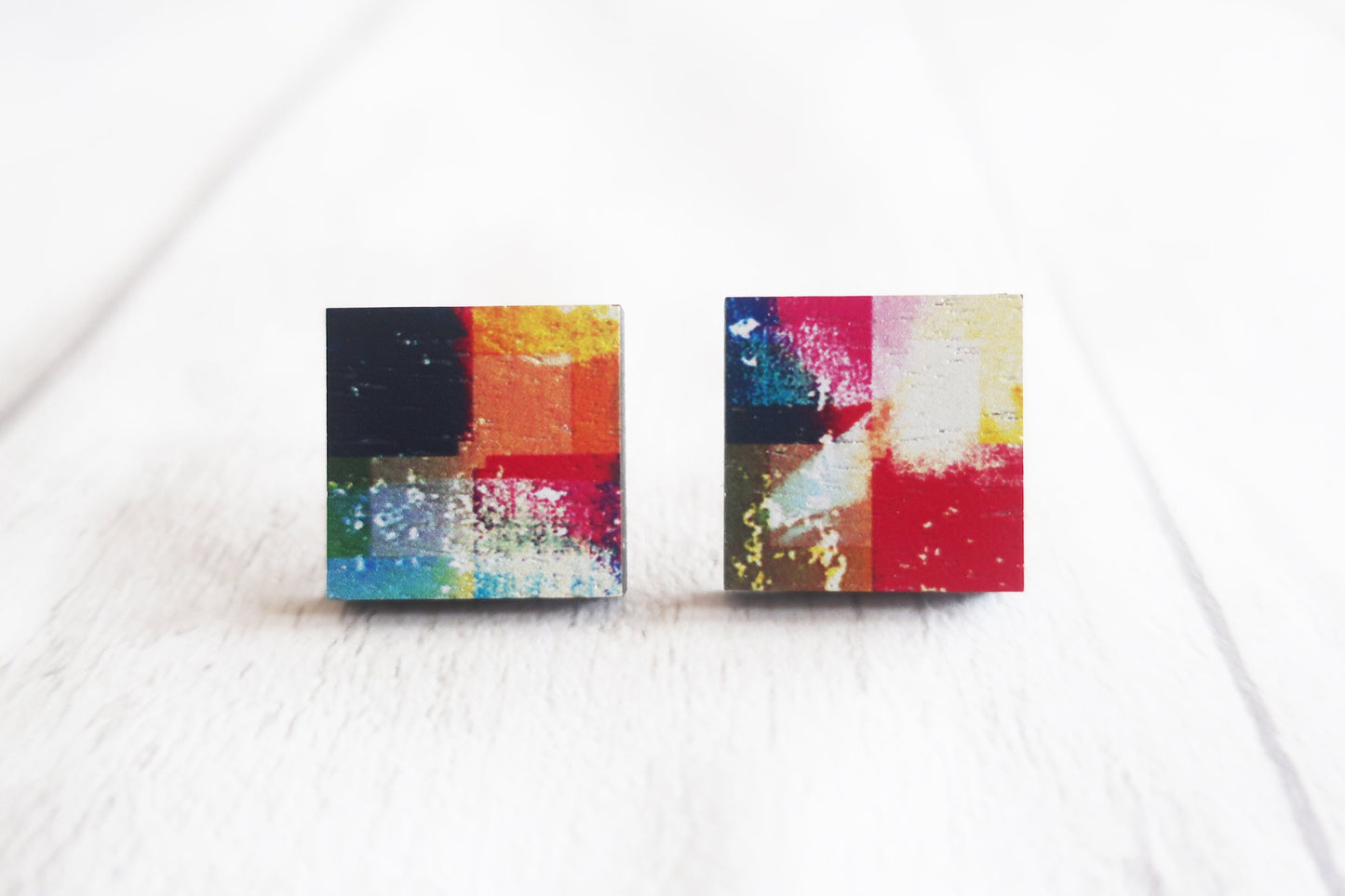 Colorful abstract patterned earrings on a white background