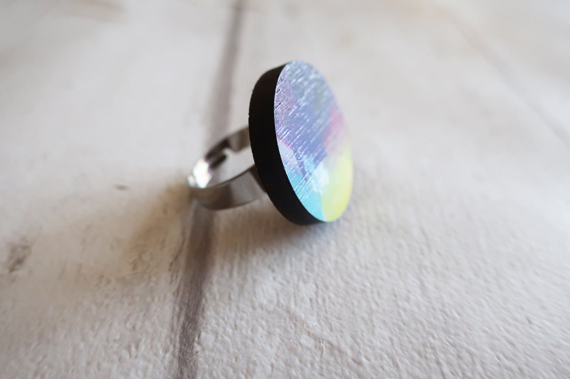 Ring with a multicolored pattern on a light background