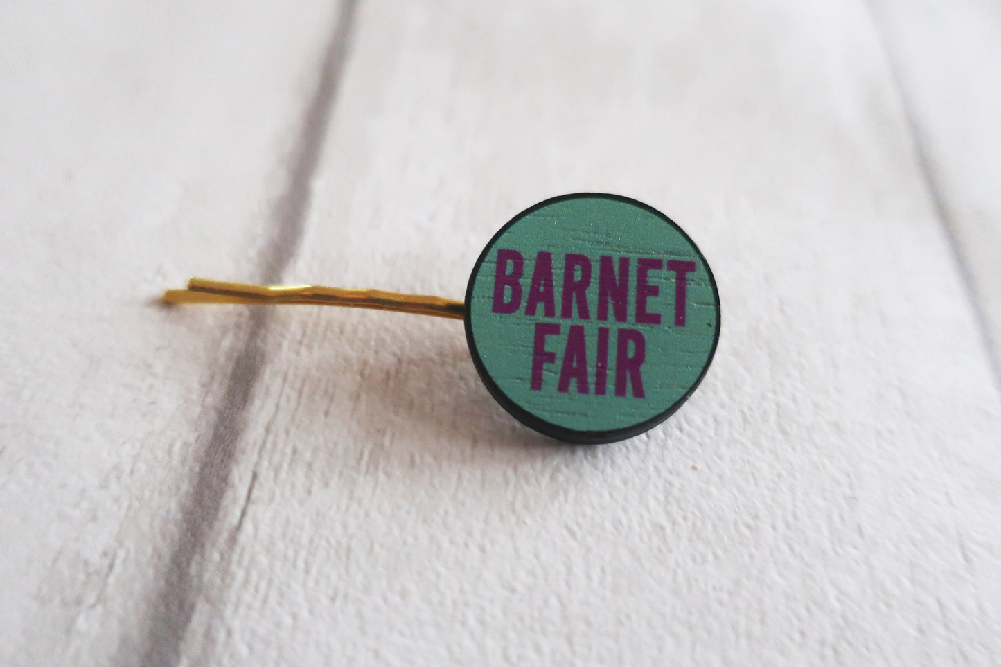 Hairpin with 'Barnet Fair' text on a white background