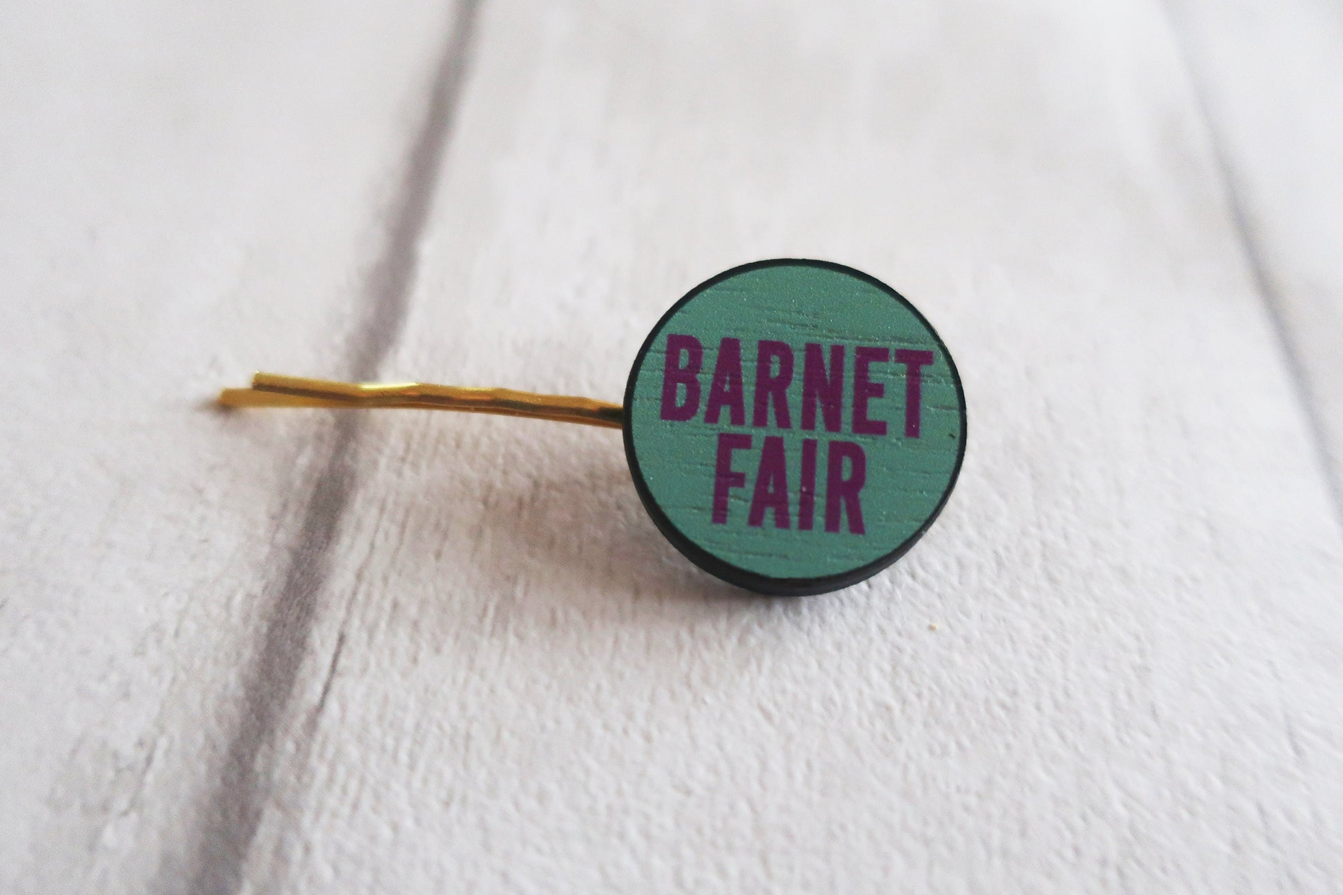 Hairpin with 'Barnet Fair' text on a white background