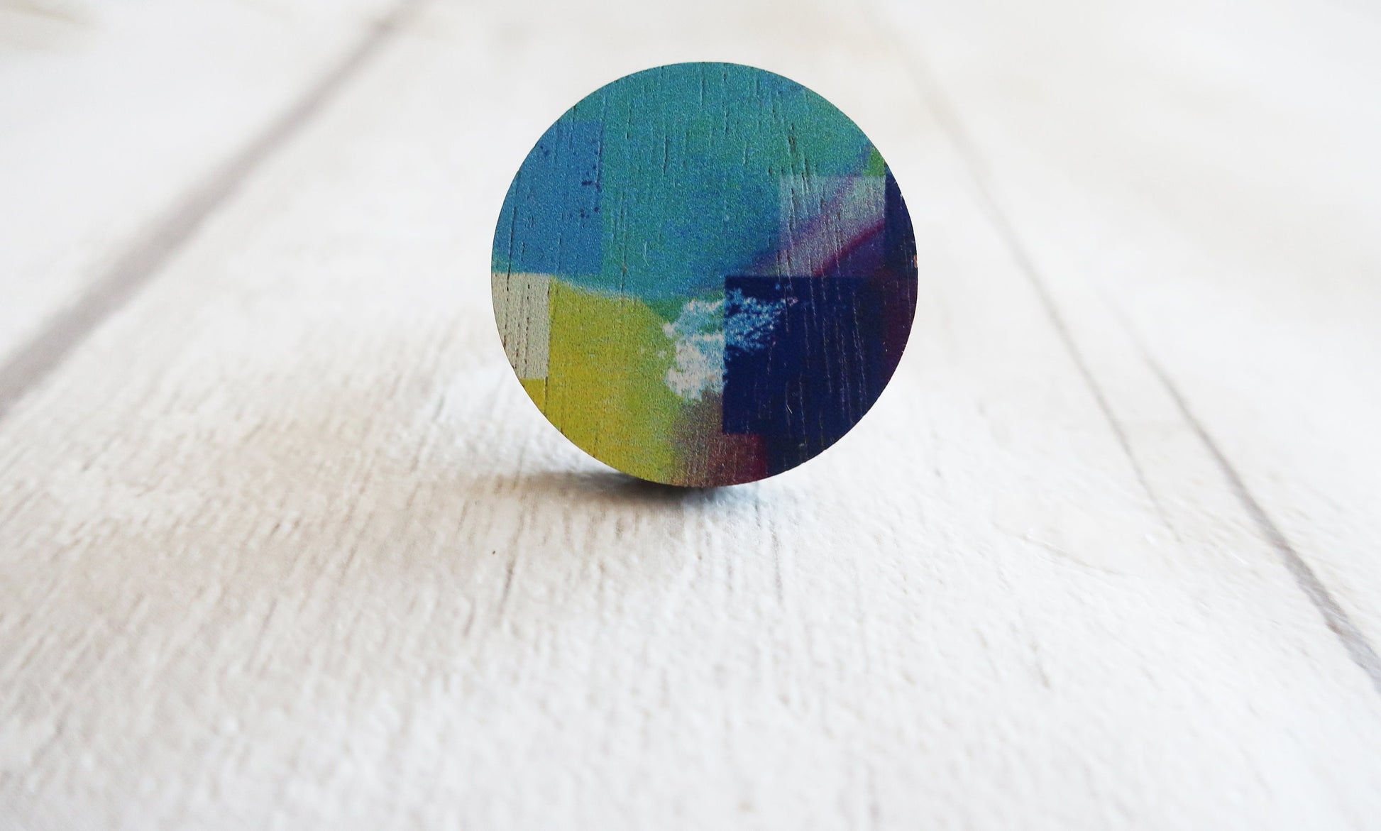 Round multicolored ring on a white surface