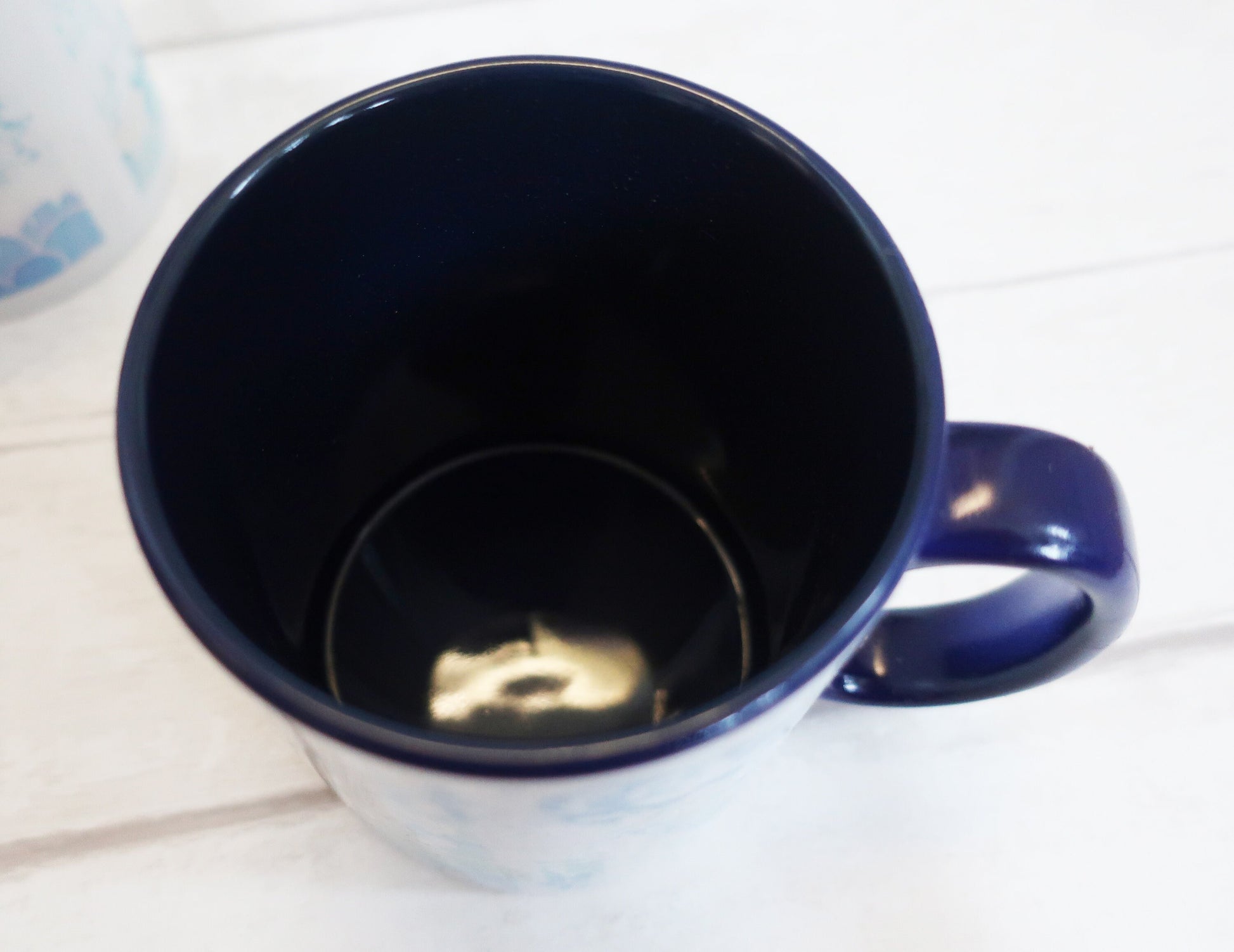 Blue ceramic mug on a white surface
