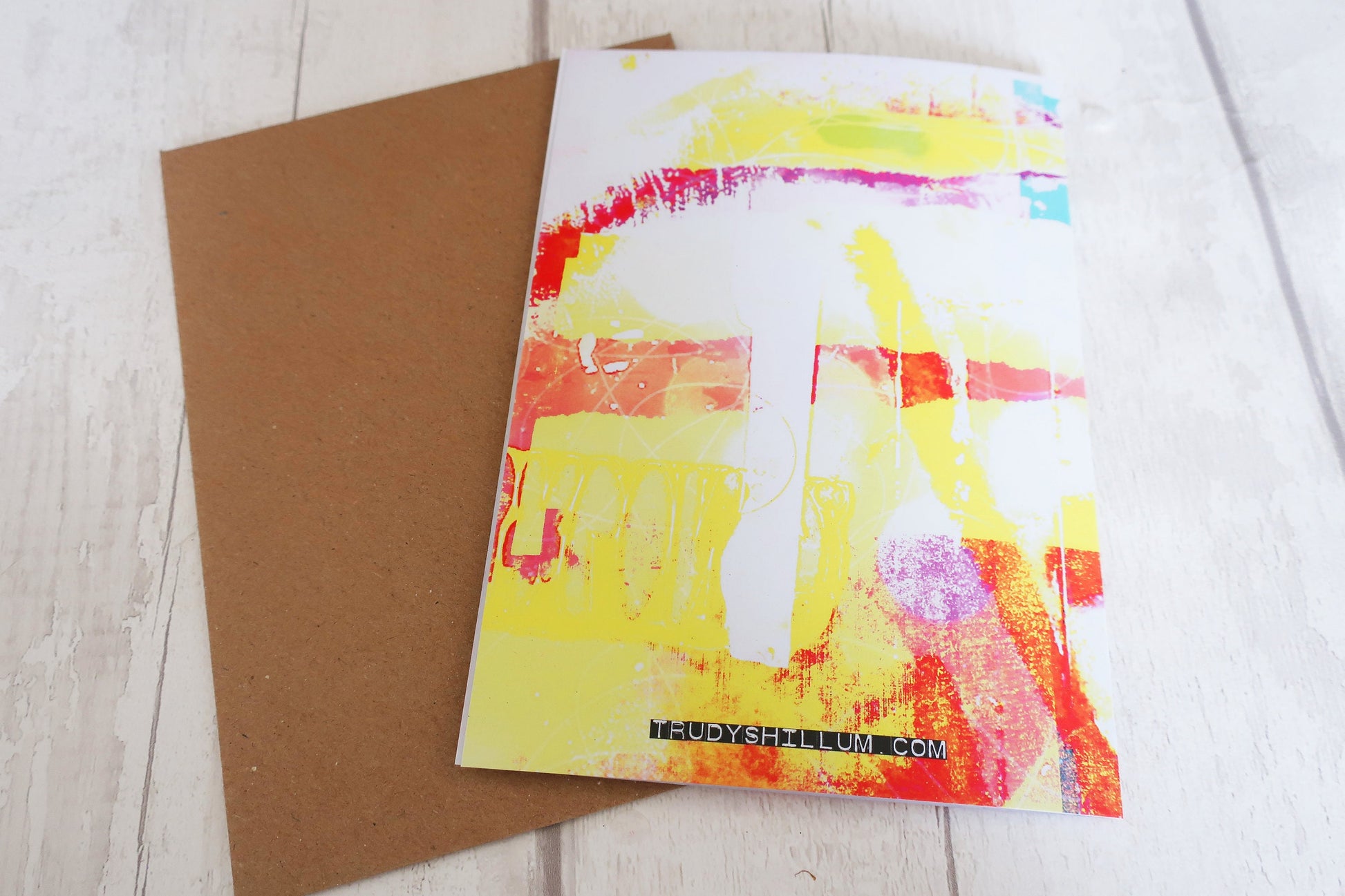 Colorful greeting card with abstract design on a wooden surface
