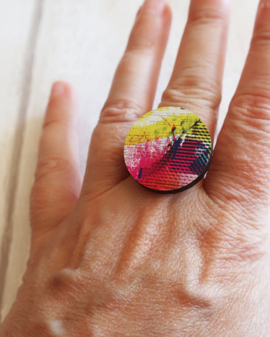 Colorful ring on a hand with a white background