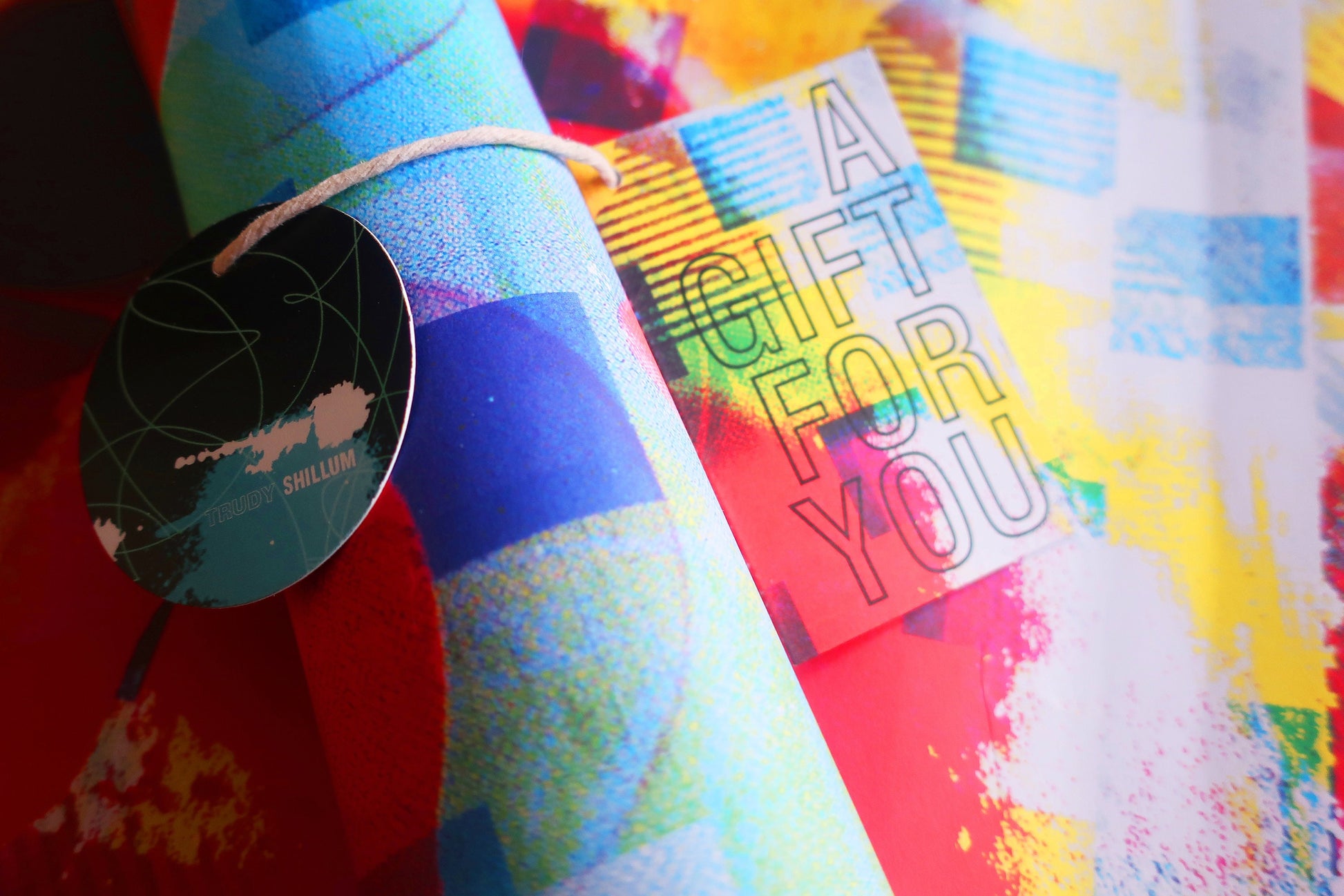 Colorful gift wrap with a 'Gift for You' tag on a multicolored background