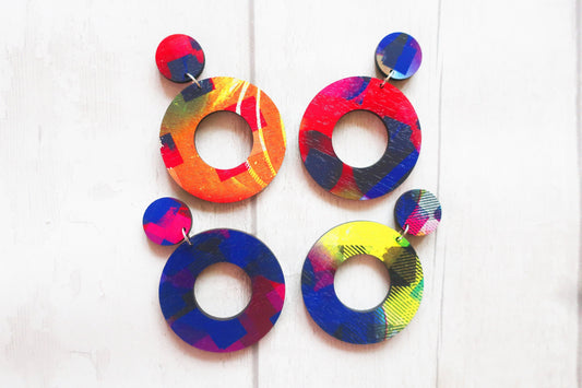 Colorful circular earrings on a white background
