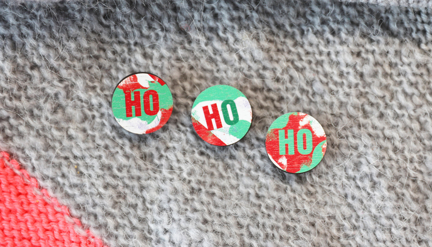 3 pin badges on a knitted scarf
