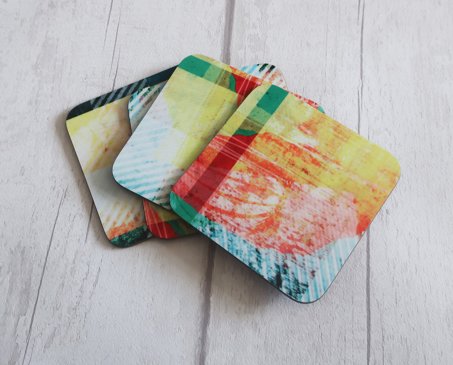 Set of colorful coasters on a light wooden surface