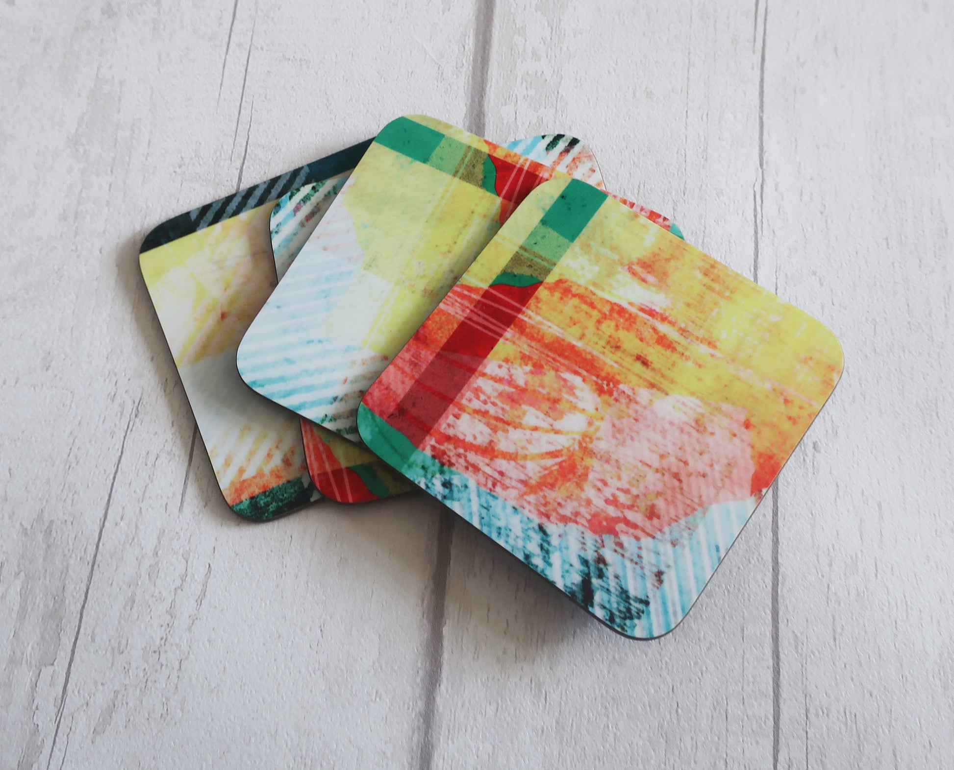 Set of colorful coasters on a light wooden surface