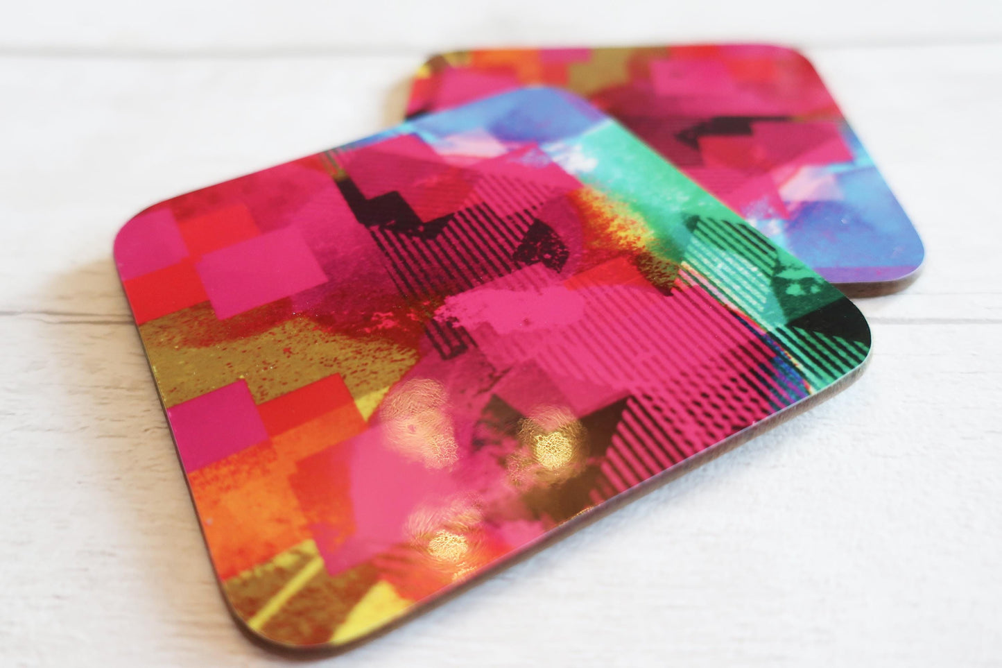 Colorful abstract patterned coasters on a white surface