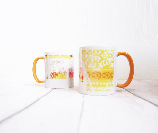 Two mugs with colorful designs on a white surface