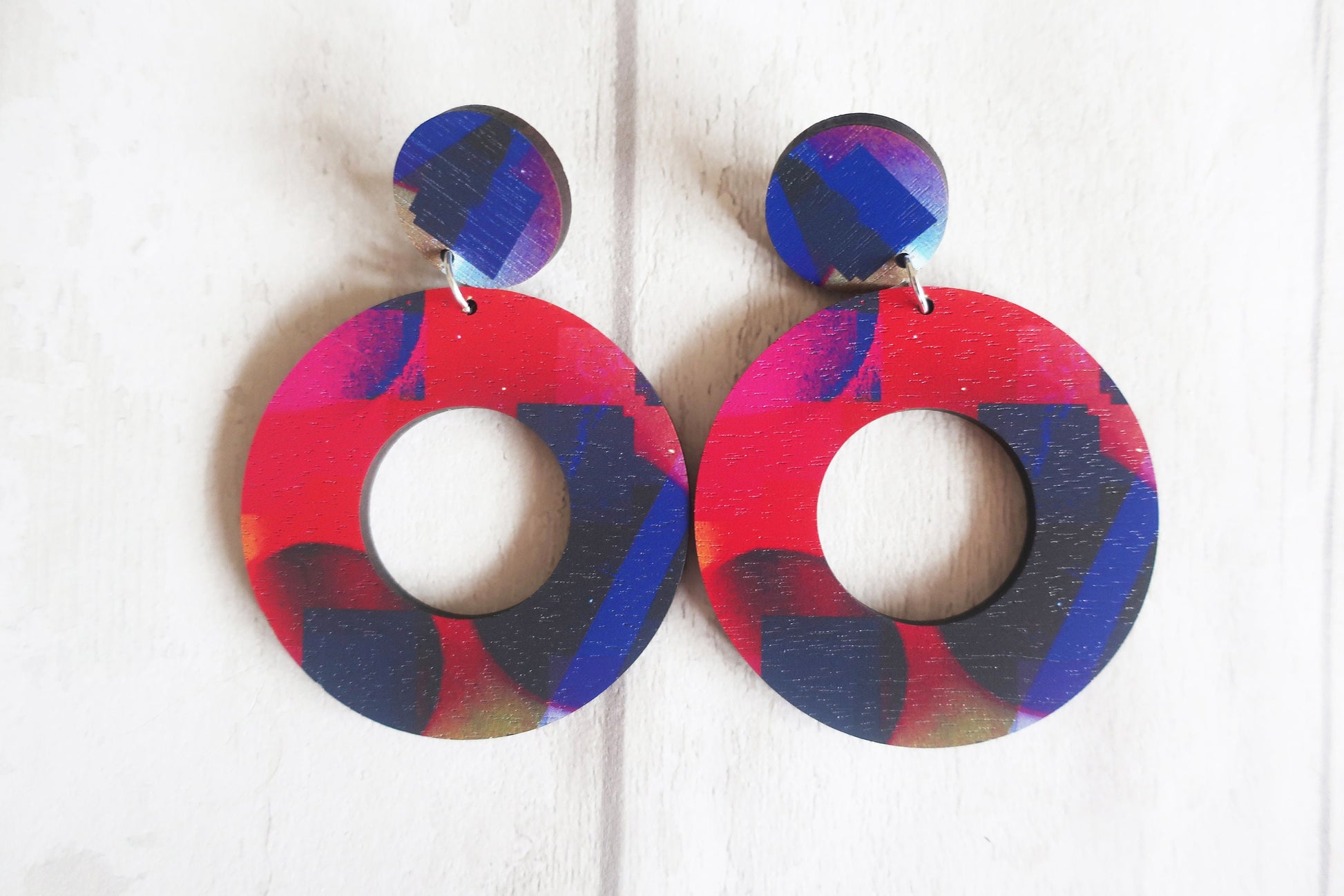 Colorful round earrings on a white background