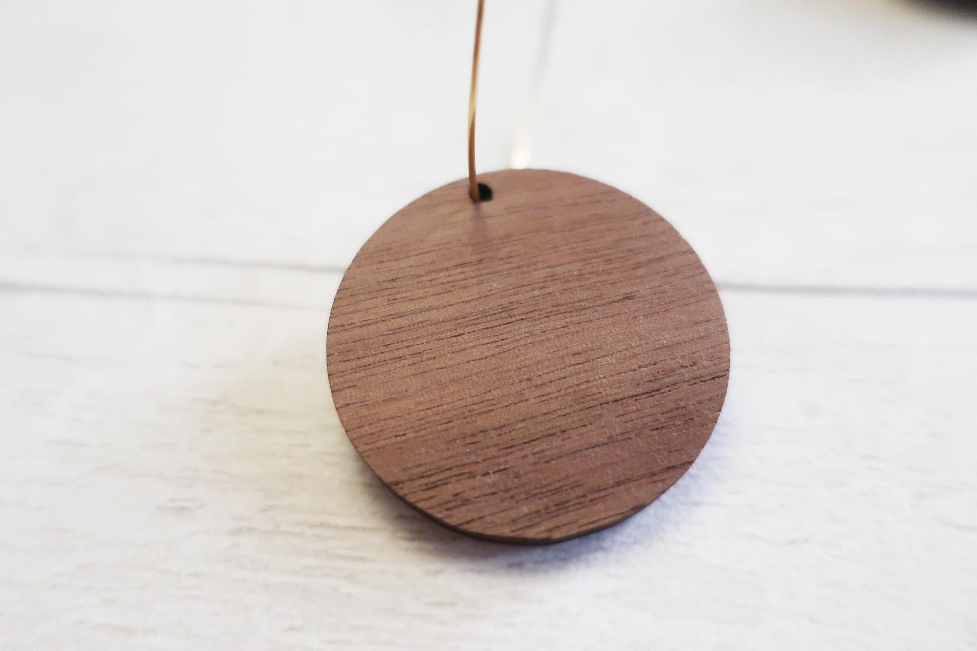 Wooden round  earring on a white background
