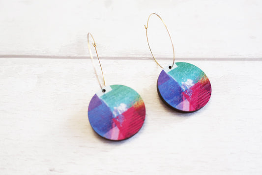 Colorful round earrings on a white background