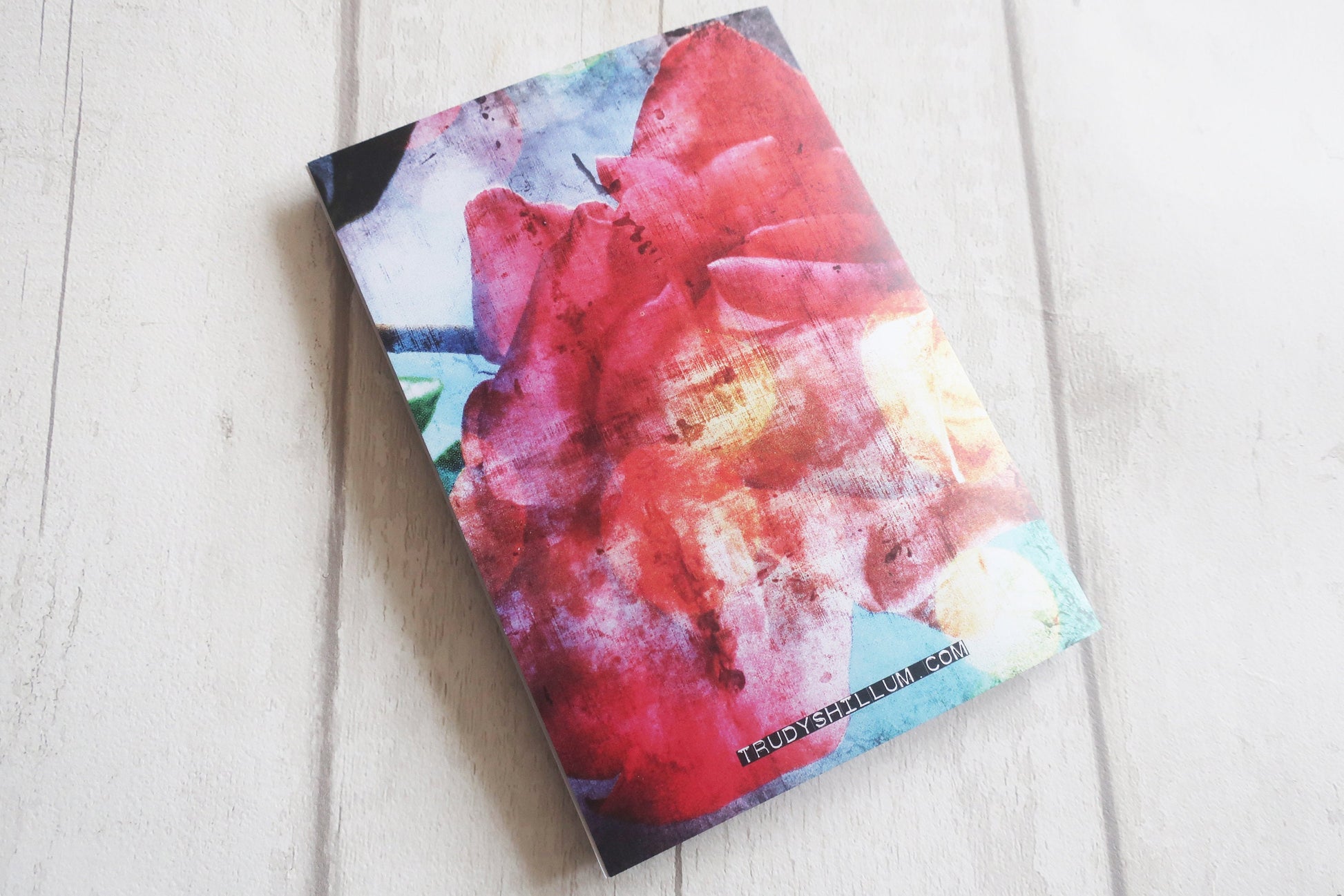 Card back with a colorful floral design on a light wooden surface