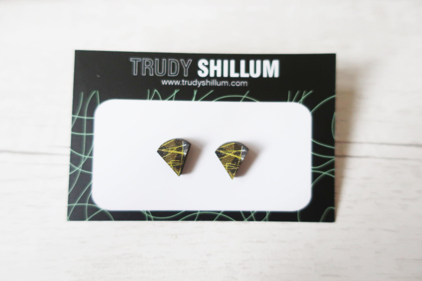 Pair of diamond-shaped earrings on a Trudy Shillum branded card.