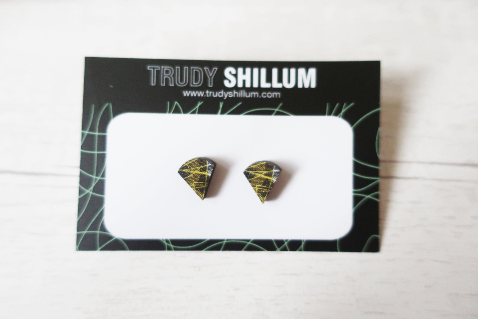 Pair of diamond-shaped earrings on a Trudy Shillum branded card.