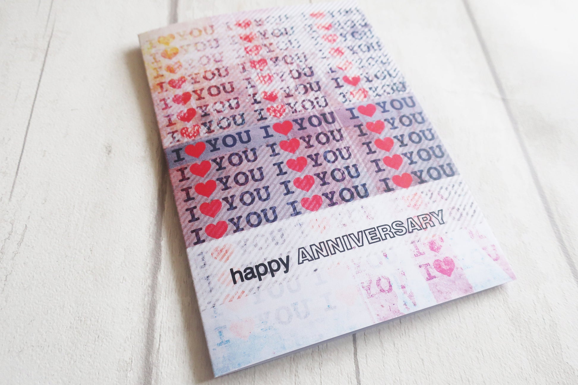 Greeting card with 'I love you' text and 'happy anniversary' on a white background