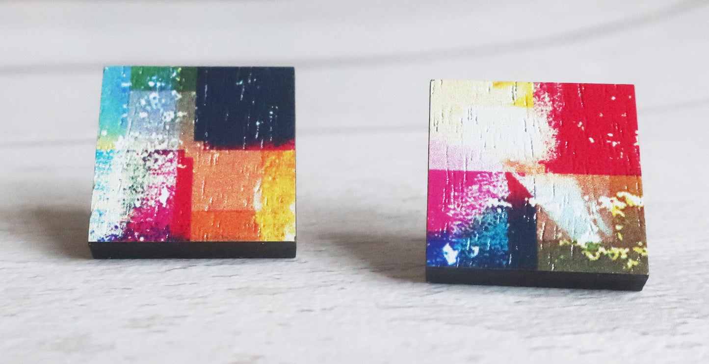 Pair of colorful square earrings on a light gray background