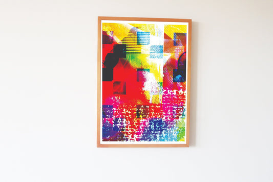 Framed abstract artwork with vibrant colors on a white wall