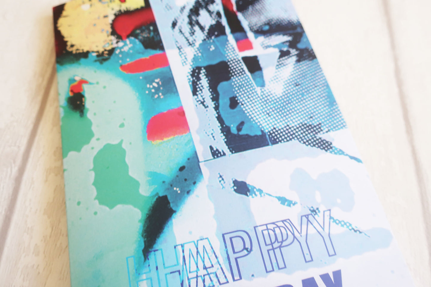 Colorful greeting card with abstract designs and 'Happy Day' text on a light background