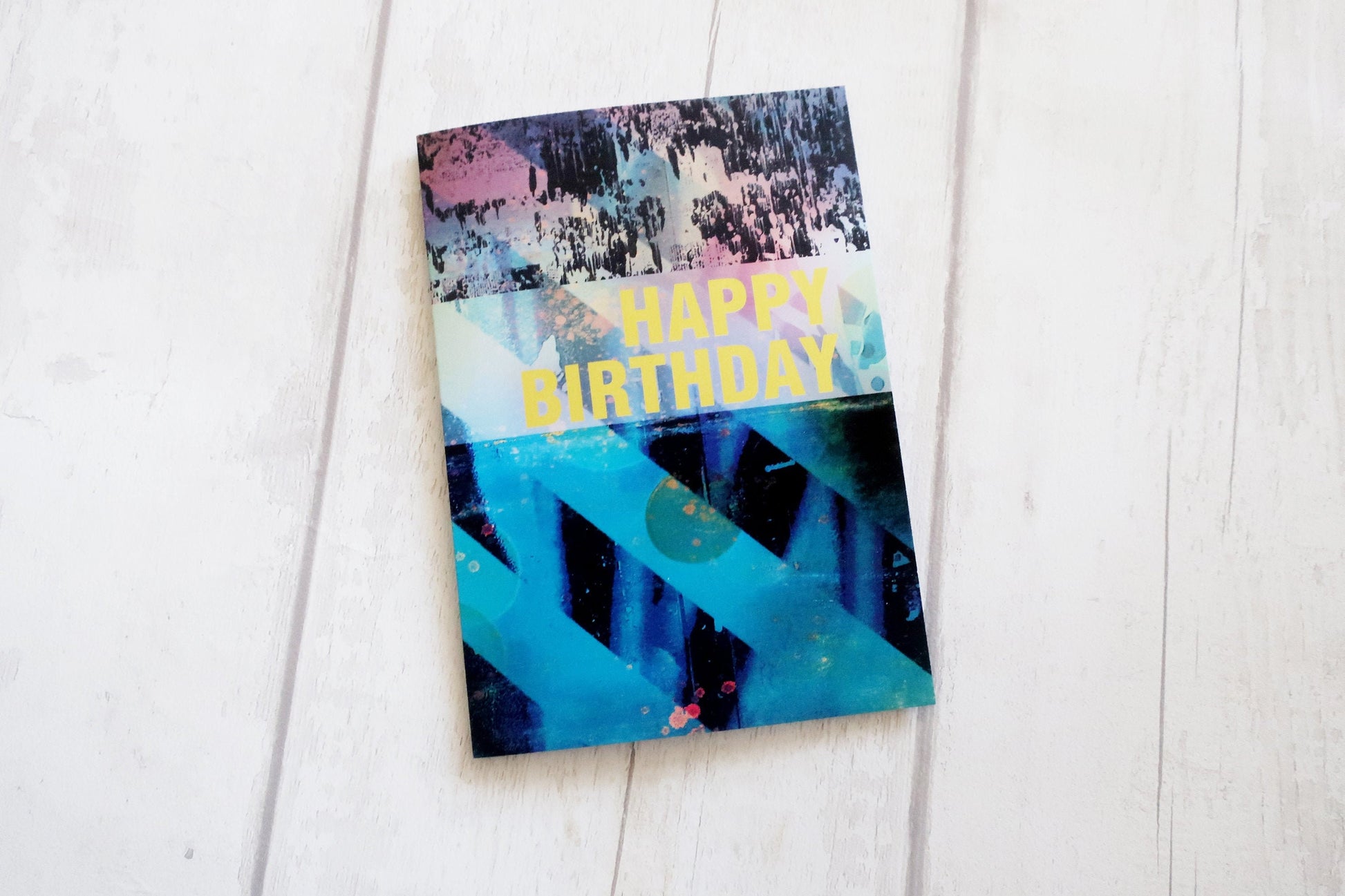 Colorful birthday card with abstract design on a white surface