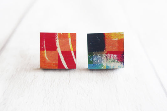Colorful square stud earrings on a white background