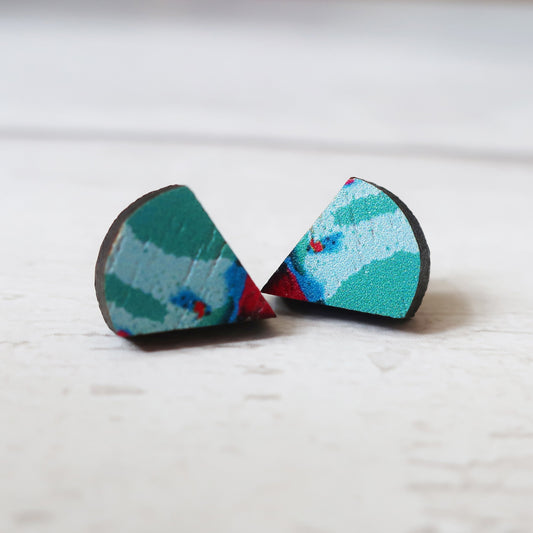 Pair of geometric earrings with a multicolor pattern on a light background