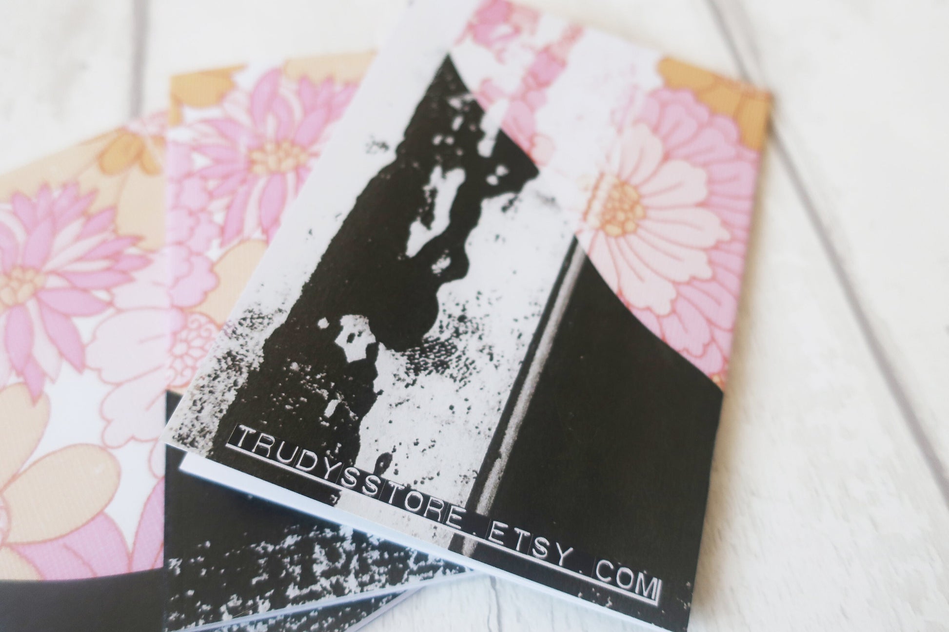 Floral and black and white note book with 'Trudy's Store' Etsy.com branding on a white surface.