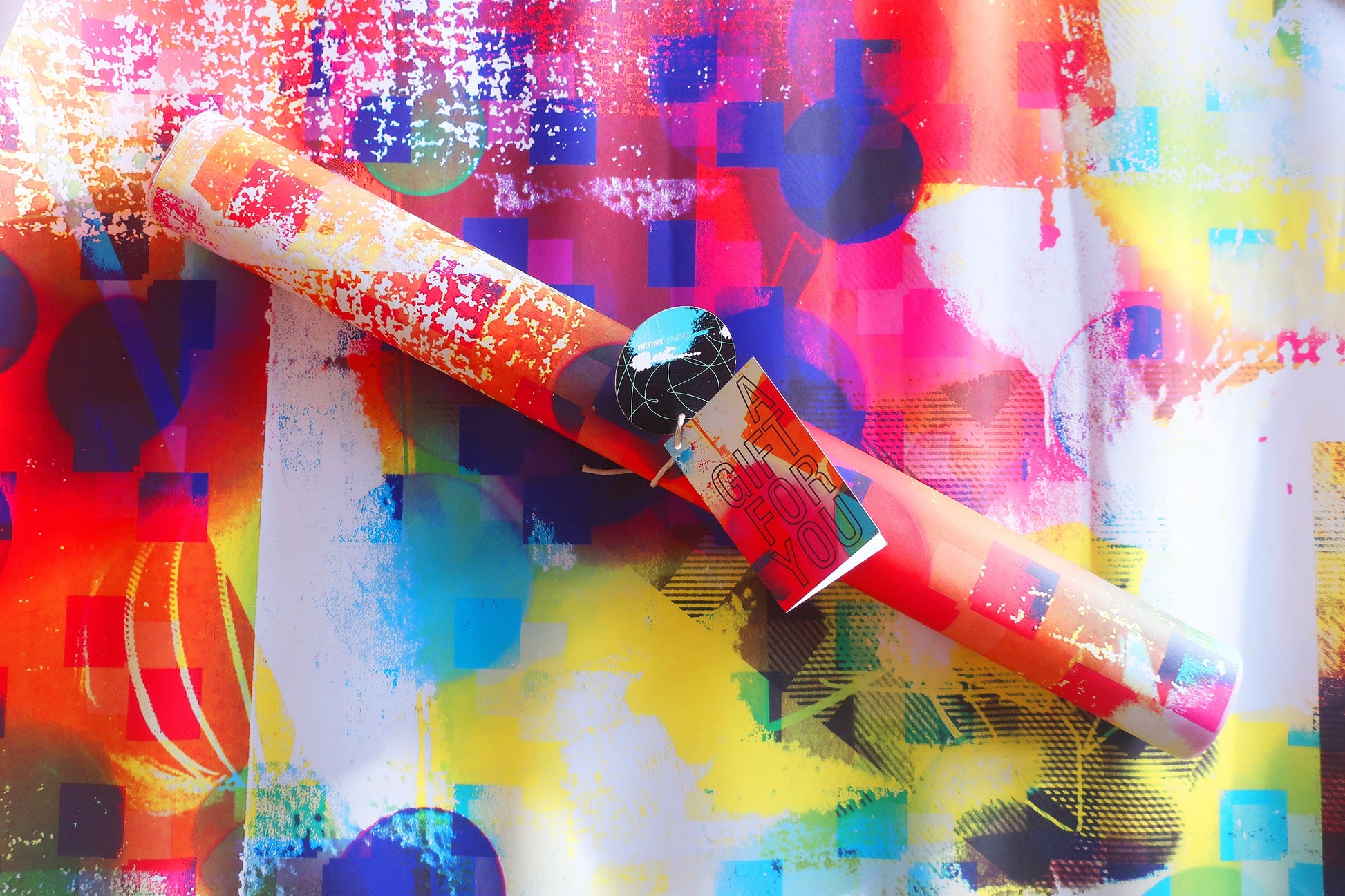 Colorful cylindrical wrapping paper with a pattern on a multicolored abstract background